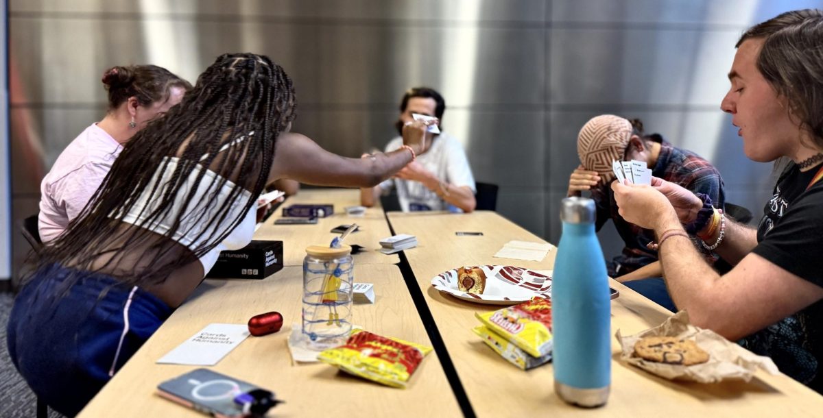 Members of UNCA Wesley during an intense game of Cards Against Humanity in Highsmith.