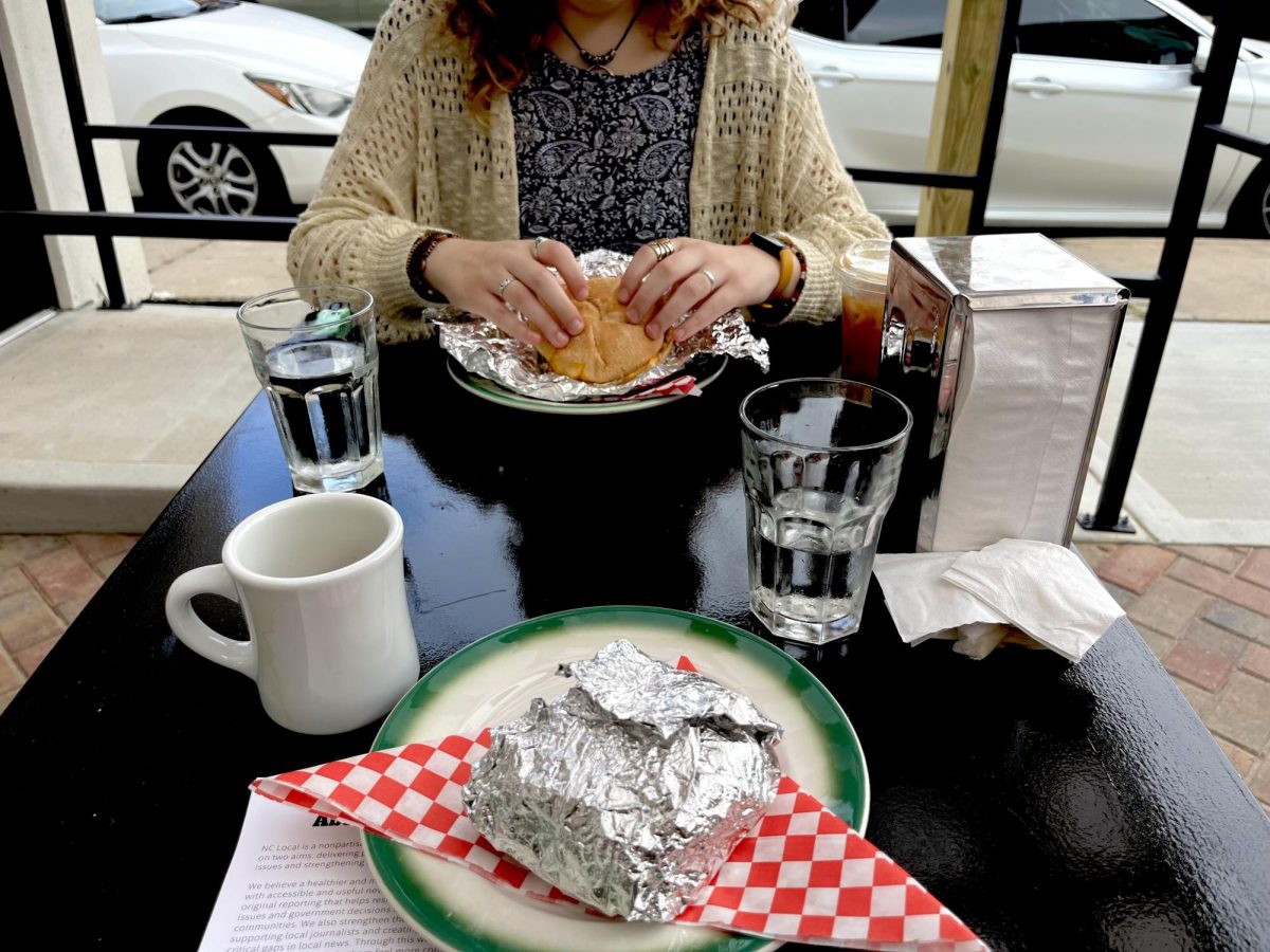 Finest Deli outside seating with student Emmie Galloway.