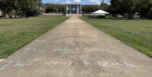 The central pathway to Ramsey Library is lined with the Latin phrase and its English translation: tyrannical leaders will inevitably be overthrown.