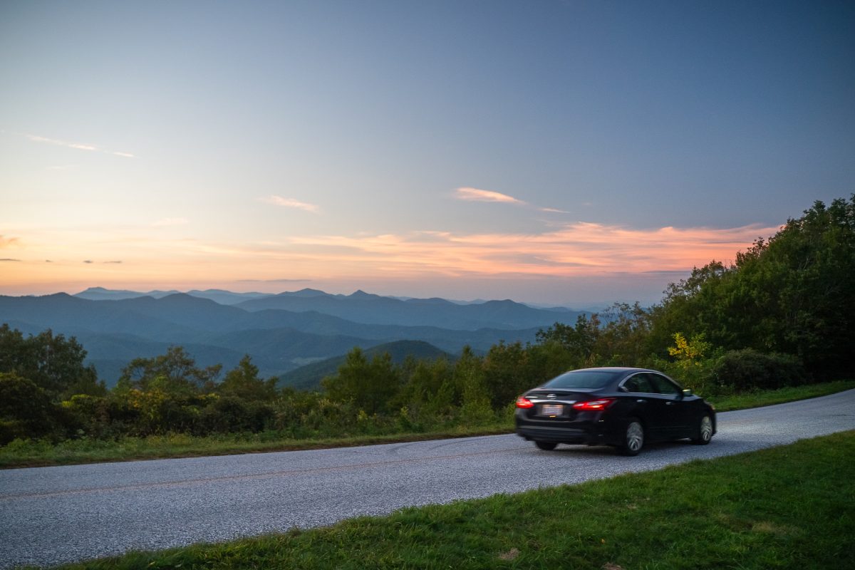 Parkway visitor drives down newly opened section of the Blue Ridge Parkway at sunset