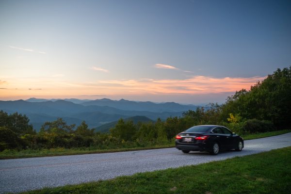 Parkway visitor drives down newly opened section of the Blue Ridge Parkway at sunset
