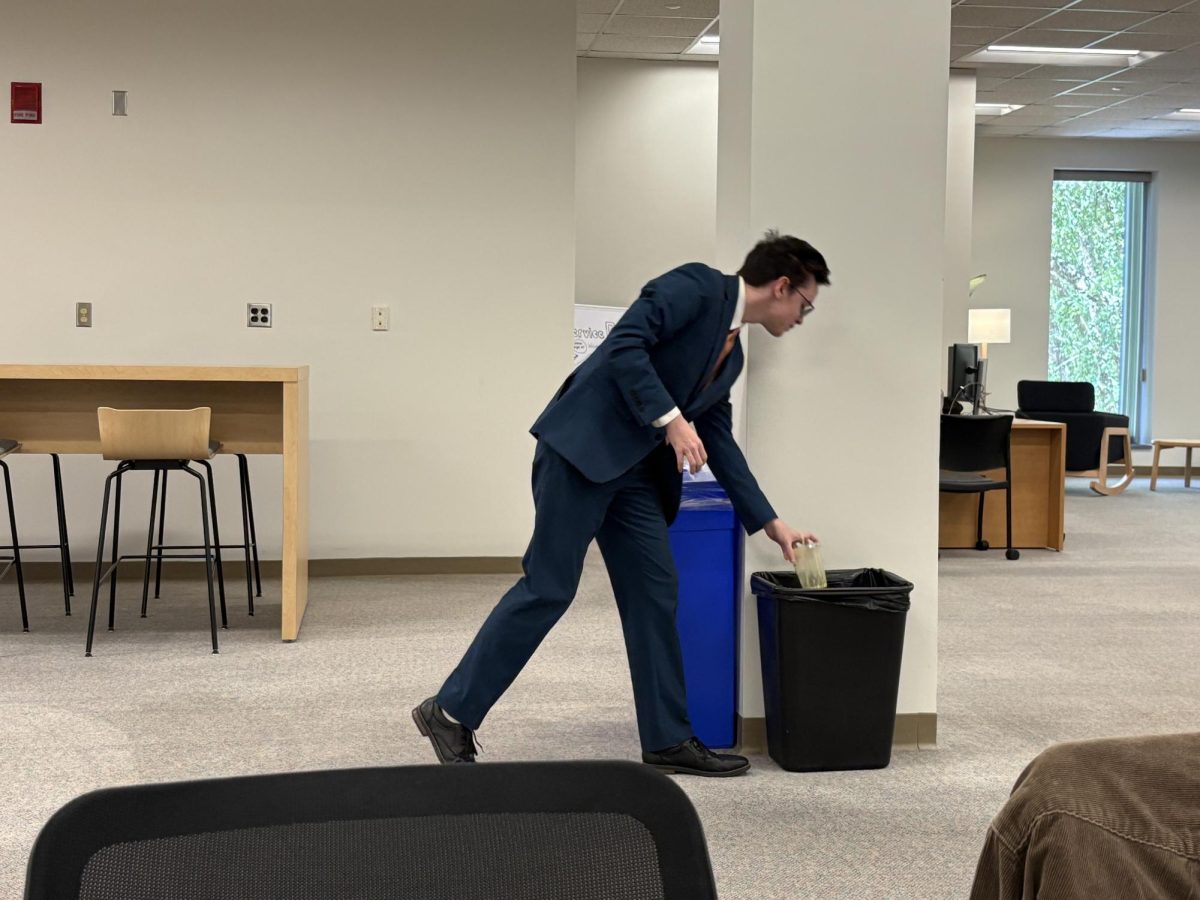 George Johnson, throws away trash 
