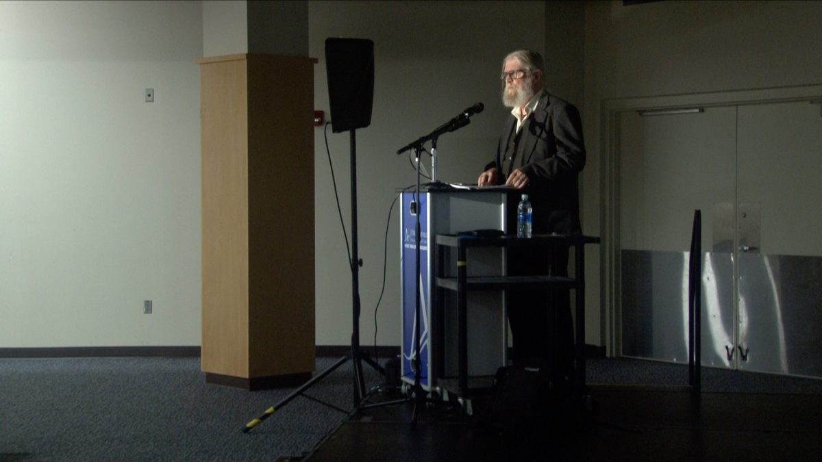Associate Professor of History in UNC Asheville, Alvis Dunn, standing for his lecture. 