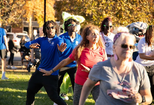 UNC Asheville student athletes participating in a Zumba session alongside Asheville community members at the 2025 Bulldog Block Party, Oct. 16. From UNCA Athletics Media Department.