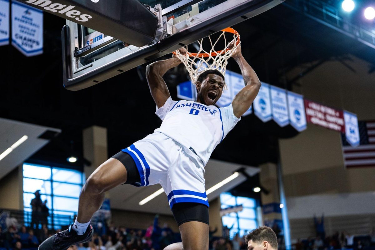 Toyaz Solomon celebrating a dunk for Asheville against High Point at home, Jan. 4. 