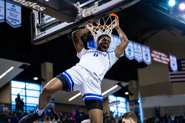 Toyaz Solomon celebrating a dunk for Asheville against High Point at home, Jan. 4. 