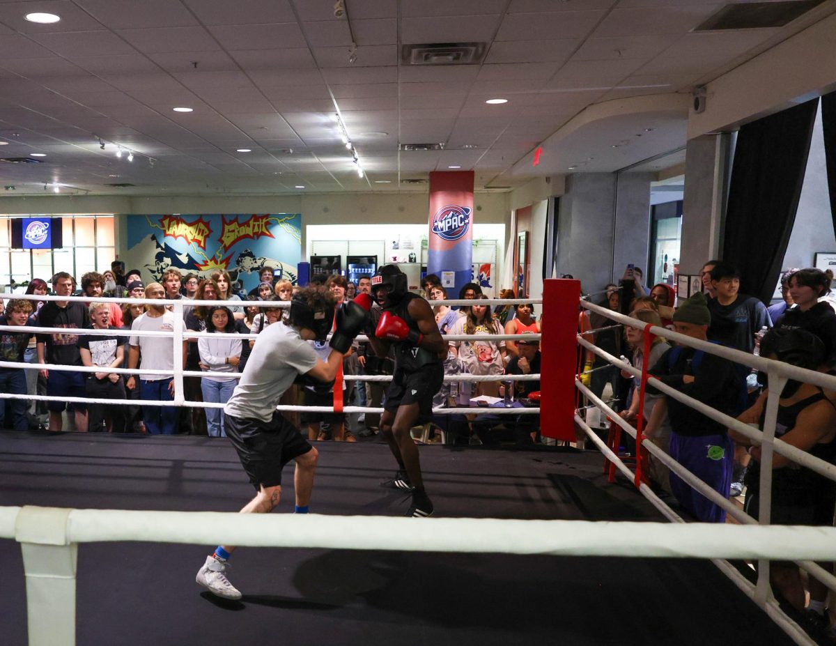 UNCA student Declan Bell (left) and App State student Aaren Dixon square up during an boxing exhibition match in Asheville, N.C.