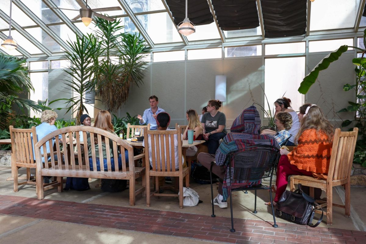 Members of UNC Asheville’s Philosophy Club converse in the Ramsey Library Green Room.