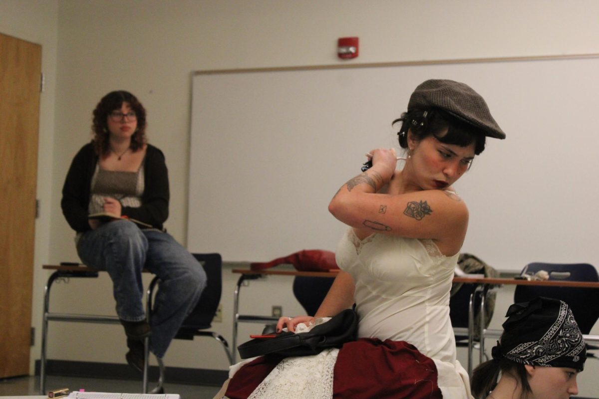 Cast members Sara Nussair and Susana Hudson run through Act 1 of “Happy Days” as director Mikaela Futrell observes, taking notes.