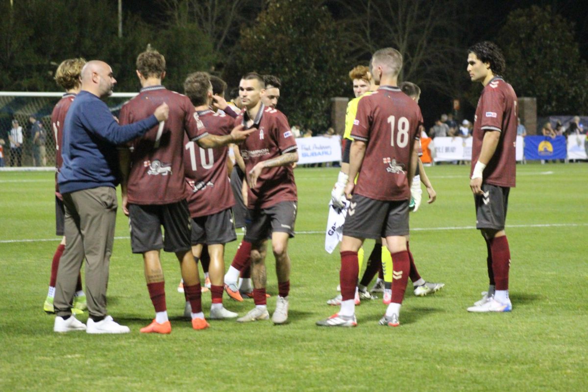 Asheville City Head Coach Scott Wells instructs his players during their match against One Knoxville on March 31