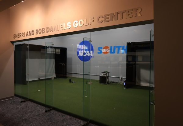 The interior of the Sherri and Rob Daniels Golf Center. The space comes with two golf simulators, a putting area and lockers for the players.