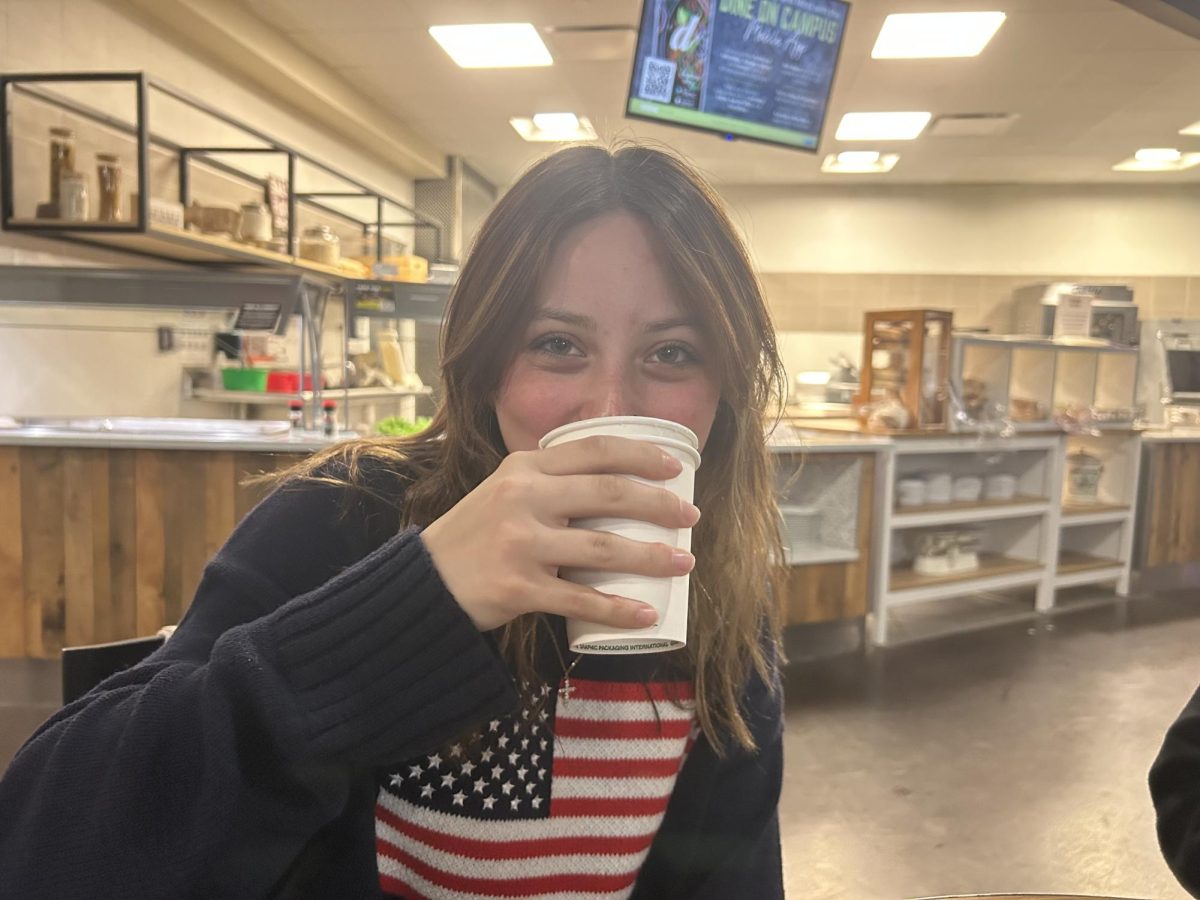 Chloe Aronson drinking some tea she made at Brown Hall.