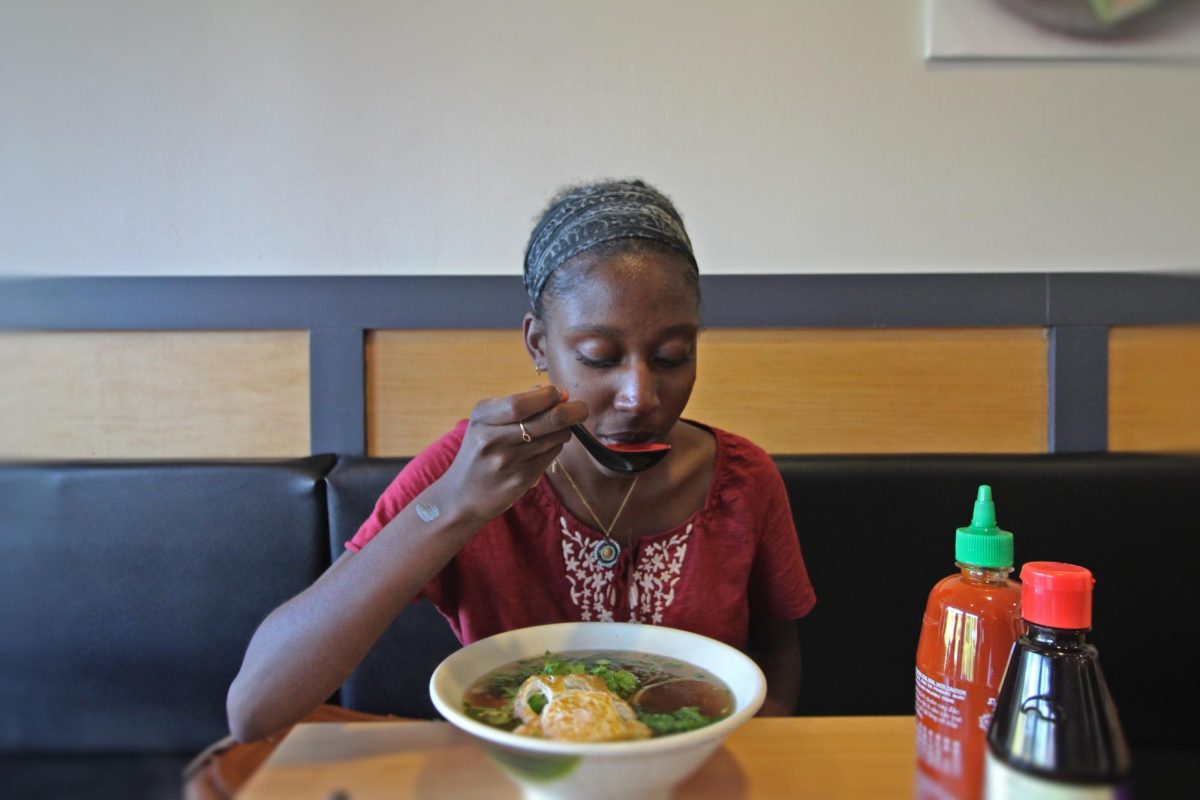 Victoria Renville enjoys a warm bowl of beef pho from Pho Real after a long day of work.